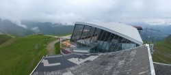Archived image Webcam Axamer Lizum: Hoadl-Haus und Top station Olympiabahn 13:00